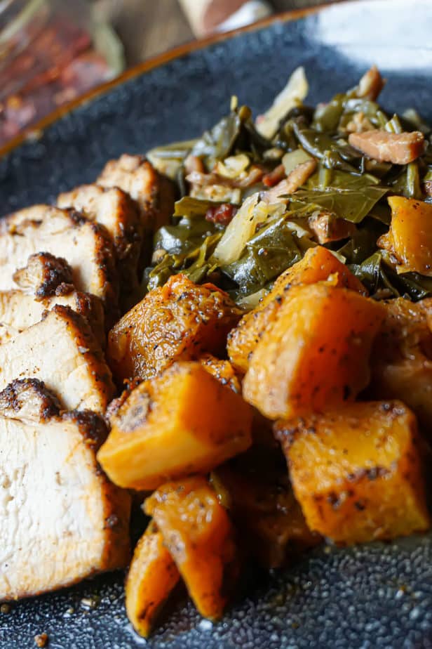 Perfectly Baked Pork Tenderloin with butternut squash and collards on a plate