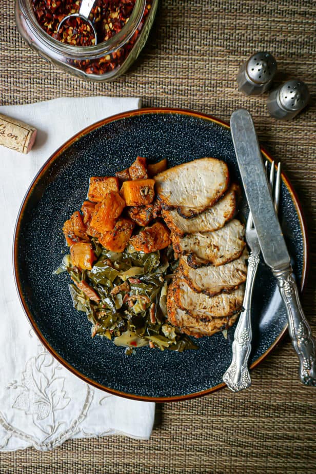 Perfectly Baked Pork Tenderloin with butternut squash and collards on a plate